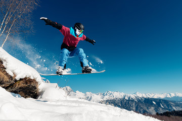 Fototapeta na wymiar snowboarder is jumping with snowboard