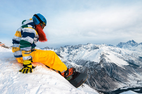 snowboarder is sitting on the mountain