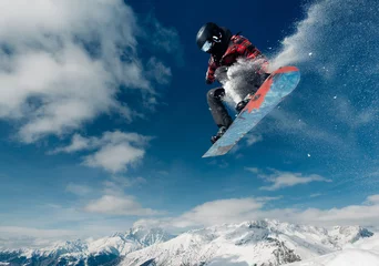 Rolgordijnen snowboarder is jumping with snowboard from snowhill © Аrtranq