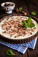 Cheesecake with vanilla mascarpone filling, cocoa crust and chocolate shavings