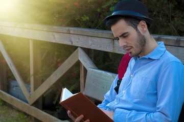 young man with the book outdoors