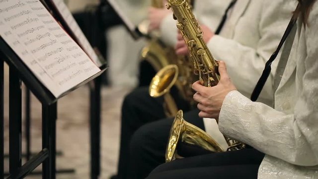 shot of Musicians is playing on saxophone in concert.