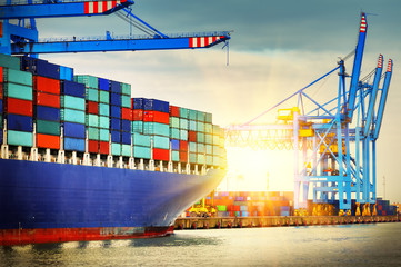 Container ship with full of cargo entering a port. Transportation background