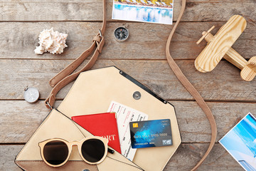 Credit card with bag and passport on wooden background