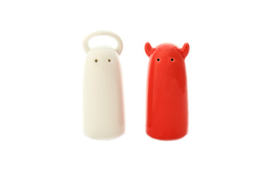 ceramic salt and pepper shakers in form of angel and demon on a white background