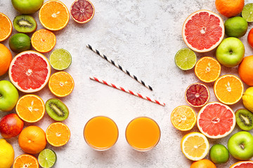 Smoothie or fresh juice vitamin drink in citrus fruits background flat lay, helthy vegetarian...
