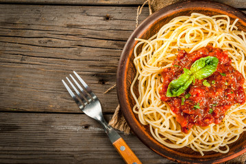 Italian cuisine. Lunch or dinner. A serving of spaghetti pasta with tomato marinara sauce and basil...