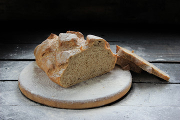 Freshly homemade bread on rustic wood background