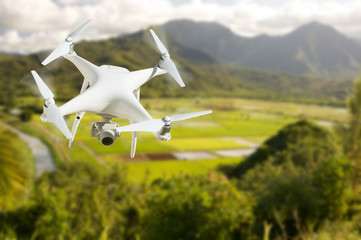 Unmanned Aircraft System (UAV) Quadcopter Drone In The Air Over Hanalei Valley and Taro Farm Fields...