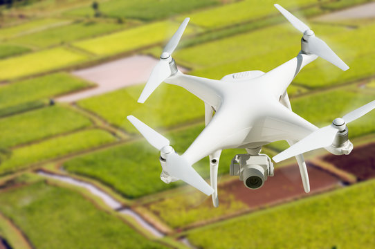 Unmanned Aircraft System (UAV) Quadcopter Drone In The Air Over Hanalei Valley and Taro Farm Fields on Kauai, Hawaii.