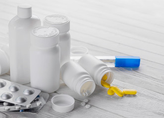 Set of pills in white bottles