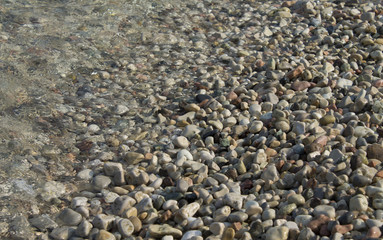 Pebbles in crystal clear lake water