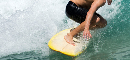 Surfer cathcing a wave in the tropics