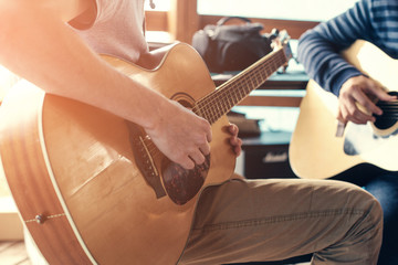 Masterclass learning to play the guitar outdoors. Musical education.