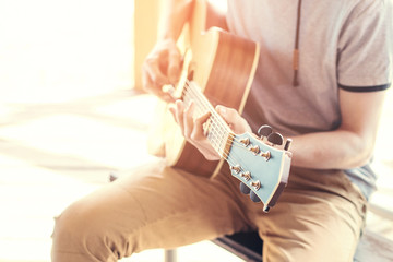 Masterclass learning to play the guitar outdoors. Musical education.