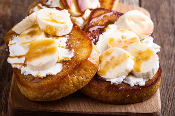 Breakfast ricotta toasts with  bananas and caramel