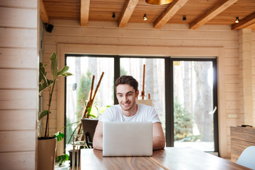 sitting with laptop in living room