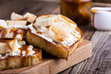 Breakfast ricotta toasts with  bananas and caramel