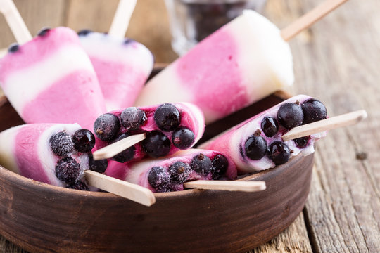 Berry yogurt ice pops with frozen blackcurrant