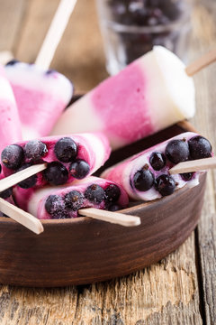 Berry yogurt ice pops with frozen blackcurrant