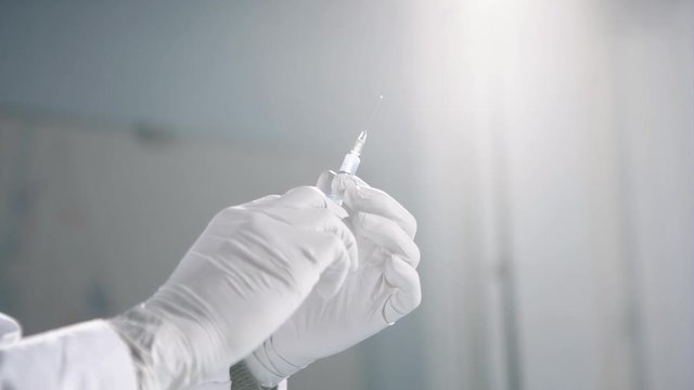 Syringe, medical injection in hand