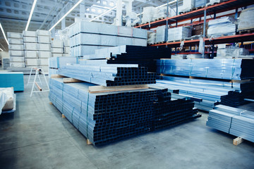 Steel, Shelf with structural materials on the shelves in the building warehouse.