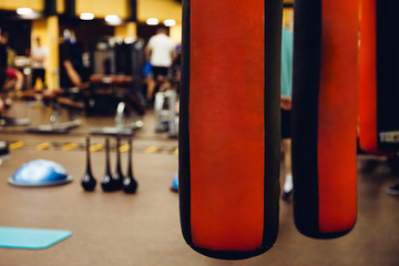 Punching bag in the gym. Against the backdrop of athletes. Gym is a cellar.