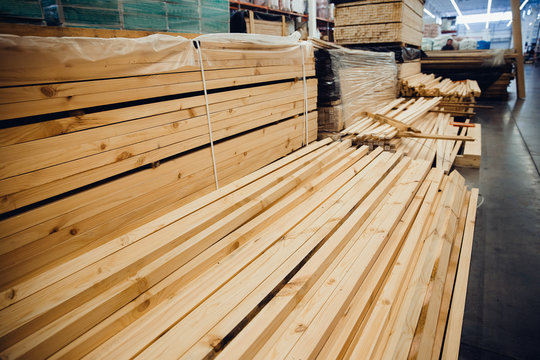 Sawn timber. Shelf with structural materials on the shelves in the construction warehouse.