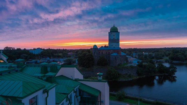 Aerial view of beautiful sunset over the Vyborg castle (Viipurin linna, Viborgs f&auml;stning) with the Tower of St. Olav, Swedish-built medieval fortress on a small island, Vyborg, Russia. Timelapse.