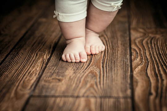 Baby feet doing the first steps. Baby's first steps.