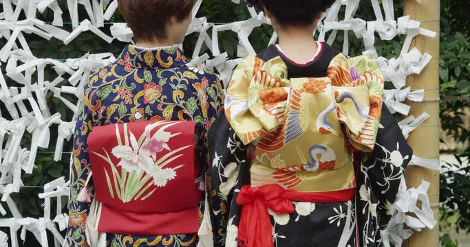 2 Japanese Women showing different kind of Obi