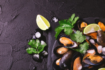 Uncooked mussels on ice with cilantro and coriander