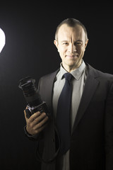 Naklejka premium Photographer in studio in suit
