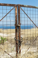 closed metal gate on the background of the sea