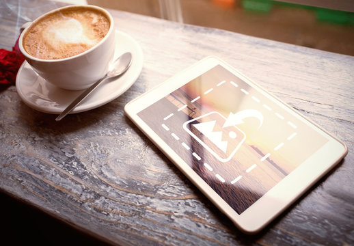 Tablet on Table with Coffee Mug Mockup 1