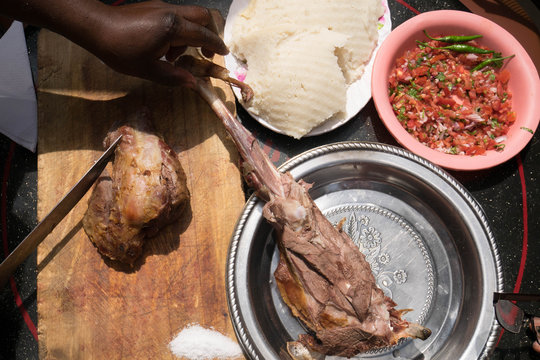 Grilled lamb meat with tomato salad and ugali,
