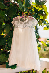 The bride's dress on a hanger in the green in Montenegro