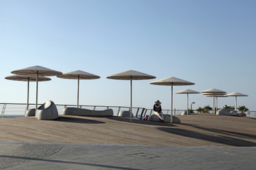 Modern beach promenade with umbrellas in Tel Aviv, Israel