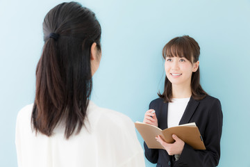 asian businesswomen talking on blue background