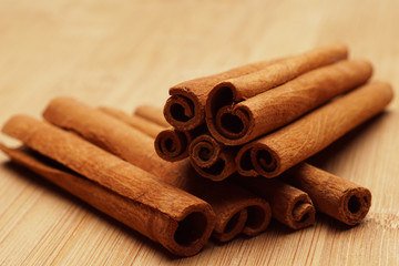 Cinnamon on wooden background