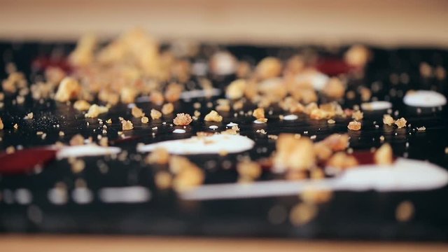 extremely closeup refocusing shot on the parts of chocolate dessert in a restaurant. Decorated with honey crumbs.