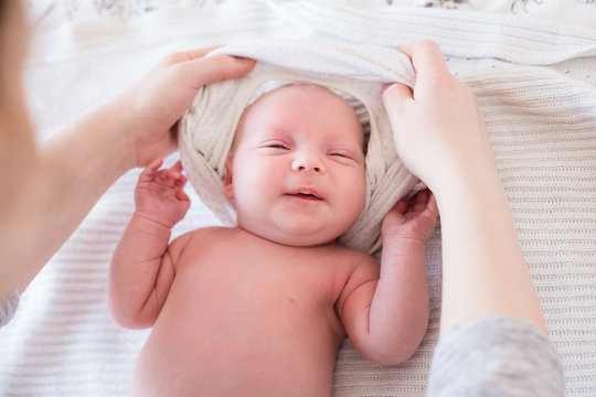 Young mother changing her newborn baby girl.