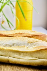 Fresh bread near yellow bottle