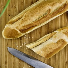 Bread and knife on wooden board
