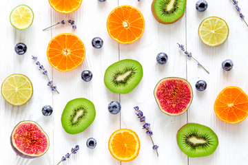 cut fruit design with blueberry and lavender on white background top view pattern