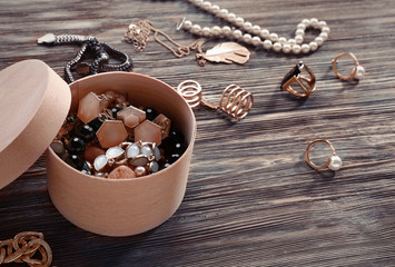 Jewelry and box on wooden background