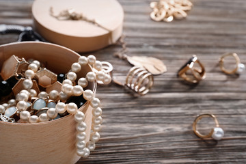 Jewelry and box on wooden background