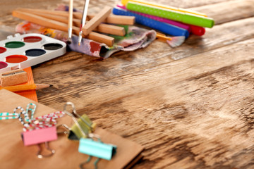Different stationery on wooden background