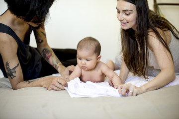 Dad Mom and Baby Happiness Together on the Bed