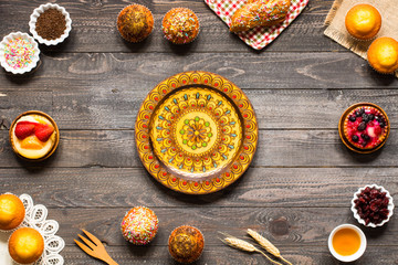 Delicious homemade muffins with yogurt, on a wooden background with space for text.